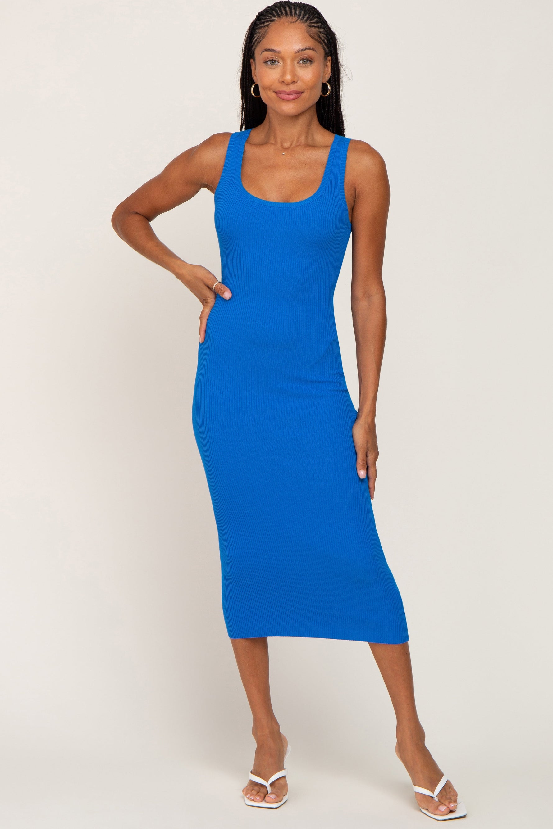 Blue sleeveless fitted midi dress with a square neckline shown on a standing model.