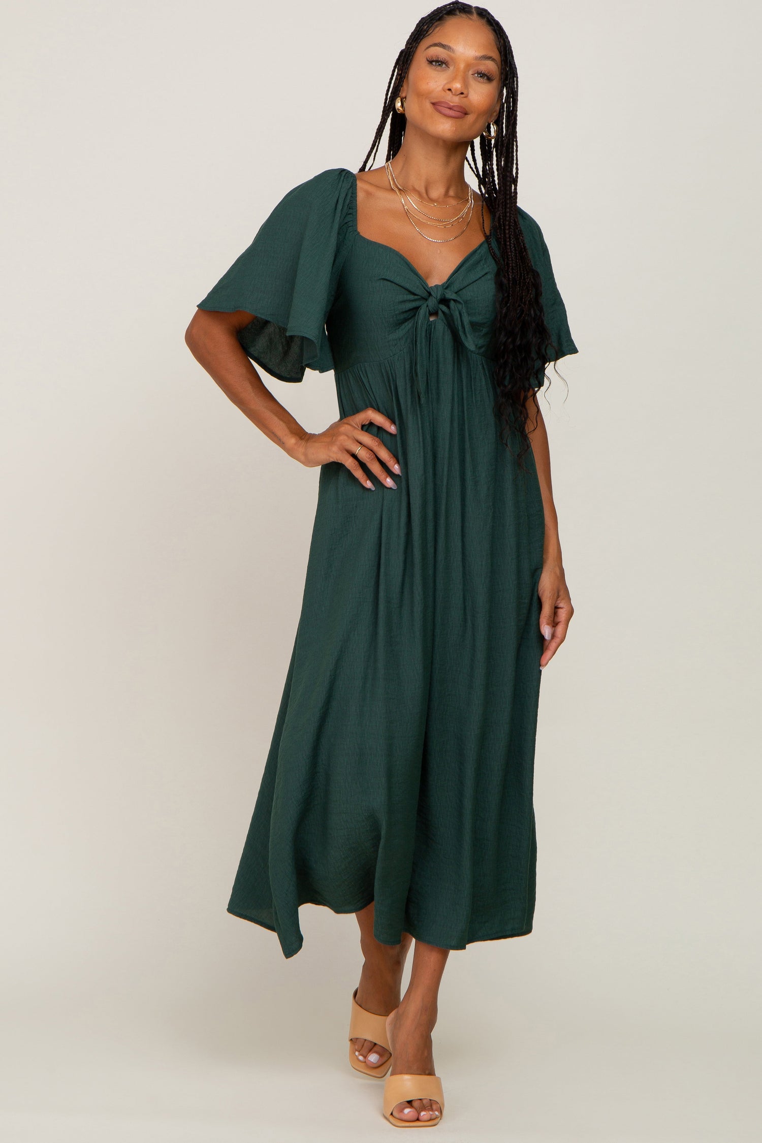 Hunter green midi dress with v-neck, front tie, cutout, ruffle sleeves and A-line skirt.