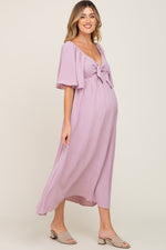 Pink textured dot front tie ruffle sleeve maternity midi dress.