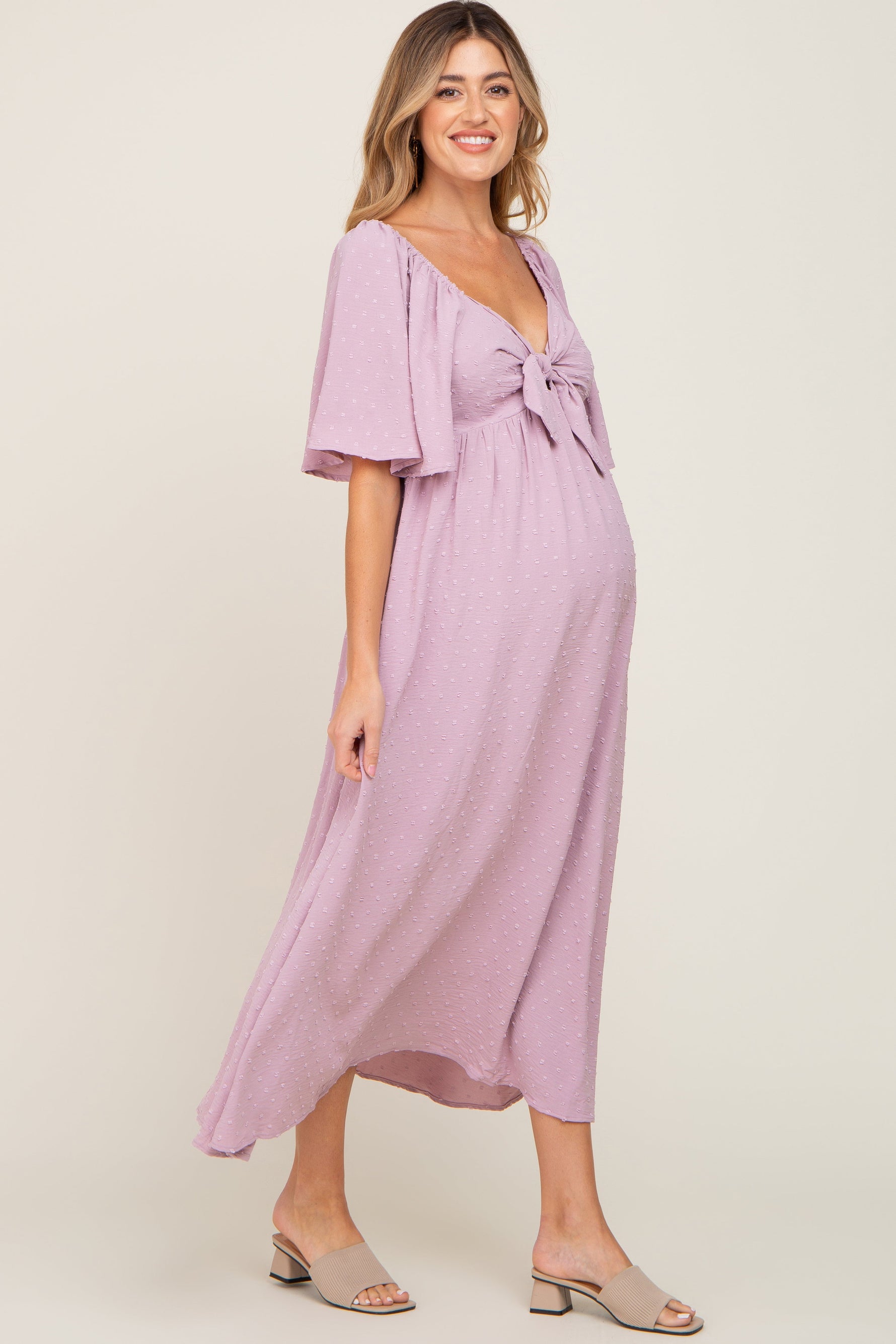 Pink textured dot front tie ruffle sleeve maternity midi dress.