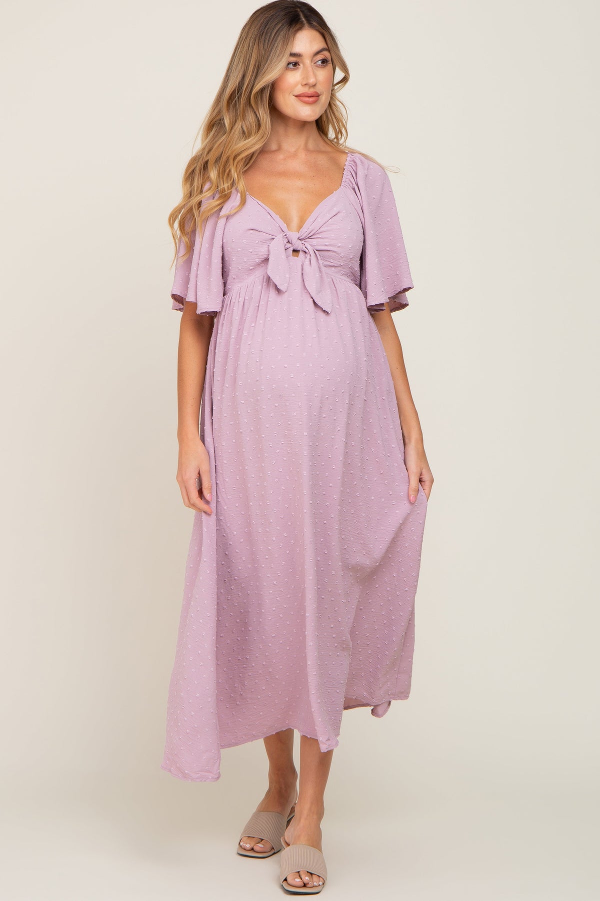 Pink textured dot front tie ruffle sleeve maternity midi dress.