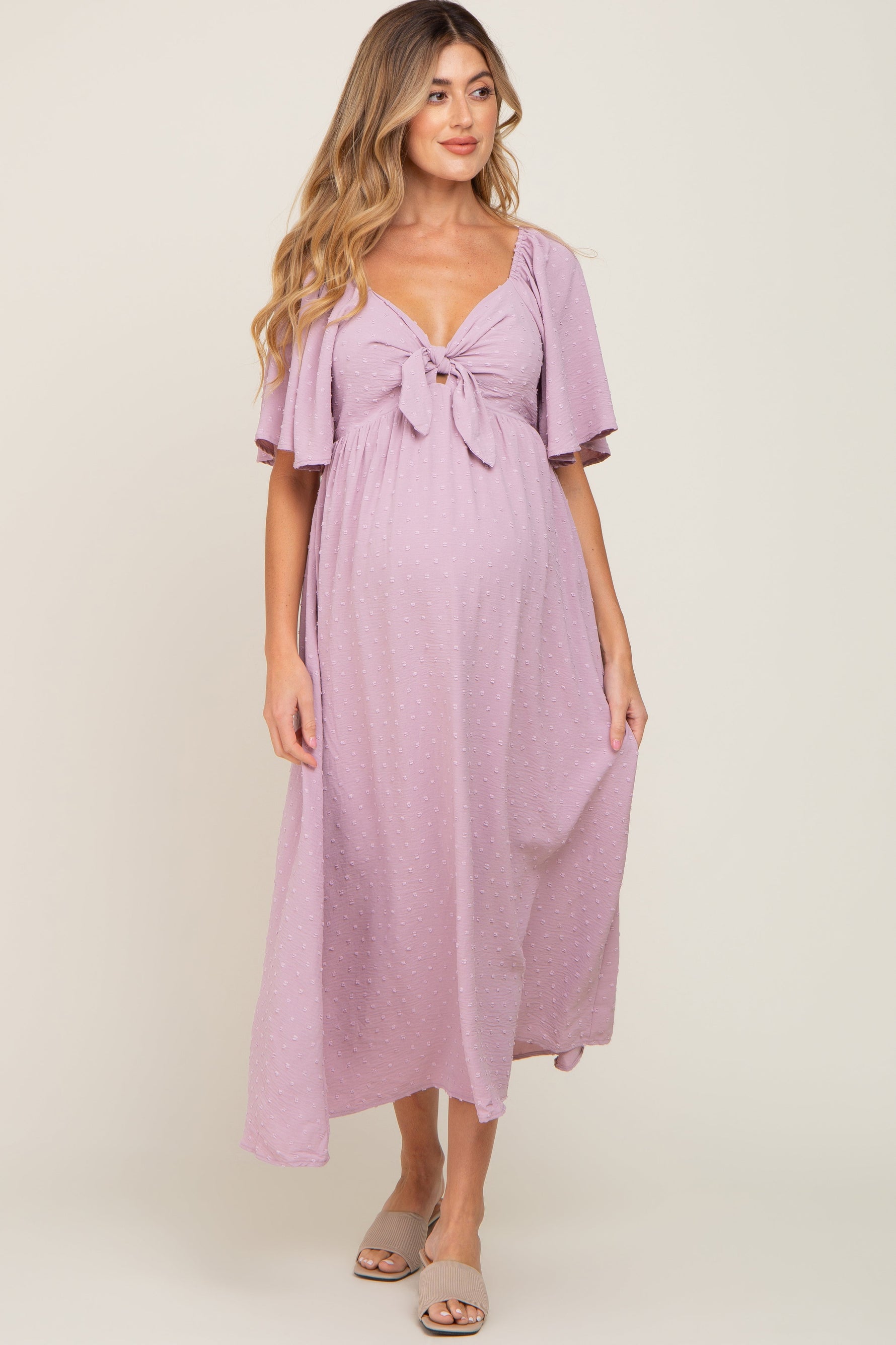 Pink textured dot front tie ruffle sleeve maternity midi dress.