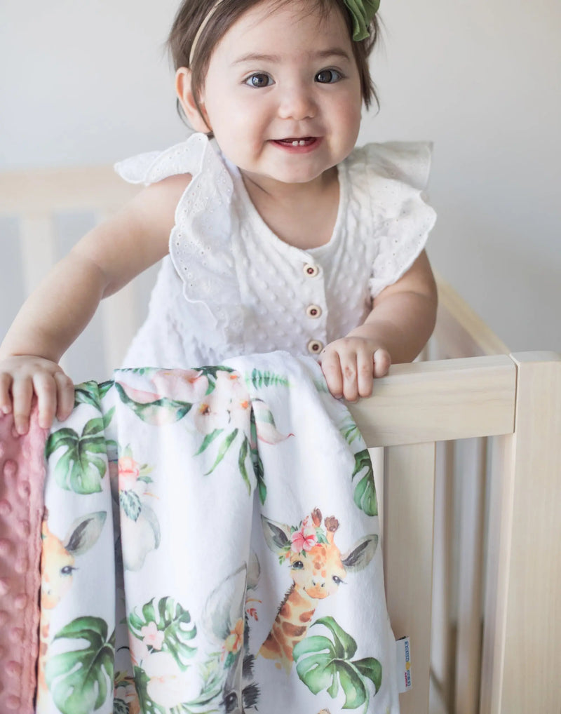 Baby & Toddler Minky Blanket with Africa Animals pattern in crib.