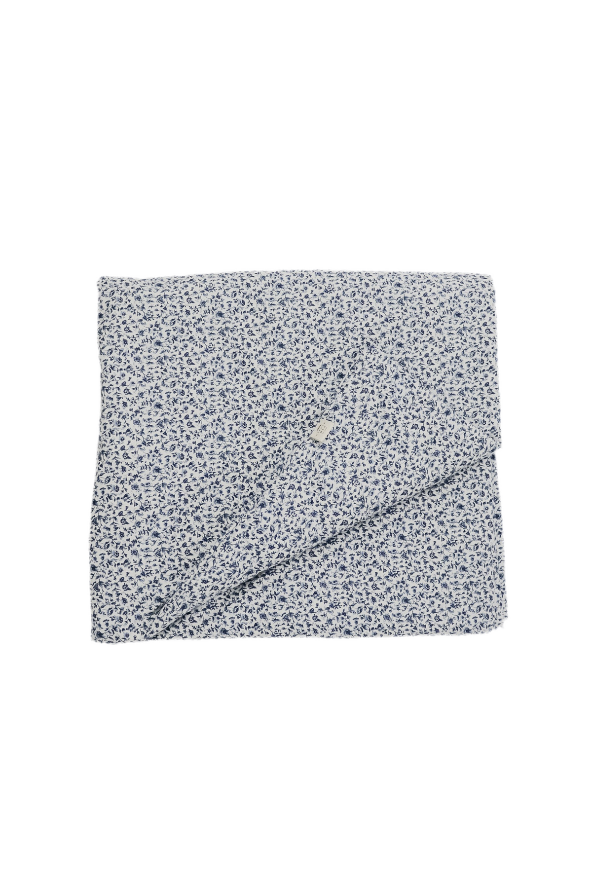 Quilted crib blanket with a floral pattern, hand-tufted with a puffy padded texture.