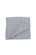 Quilted crib blanket with a floral pattern, hand-tufted with a puffy padded texture.