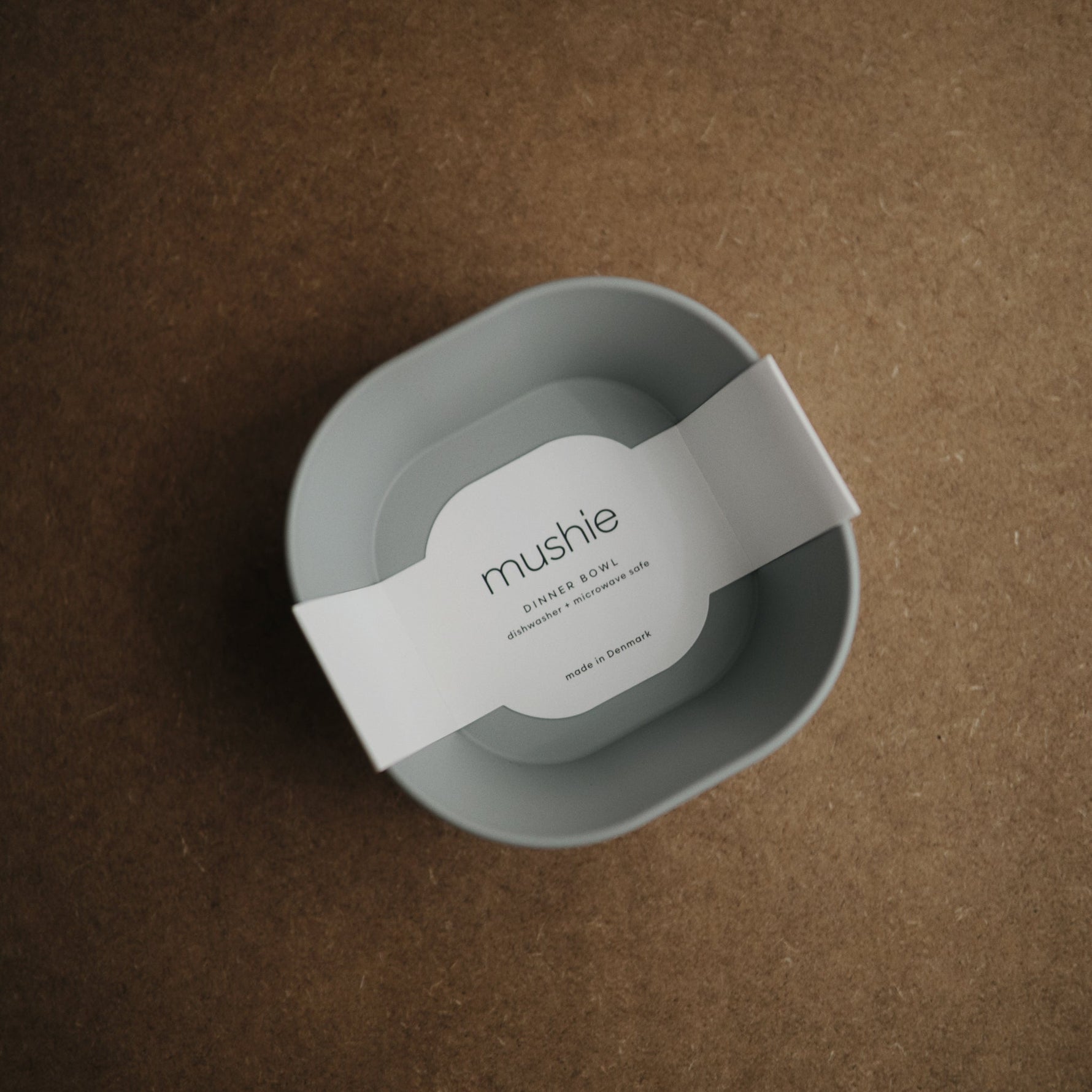 Mushie square silicone baby feeding bowls.