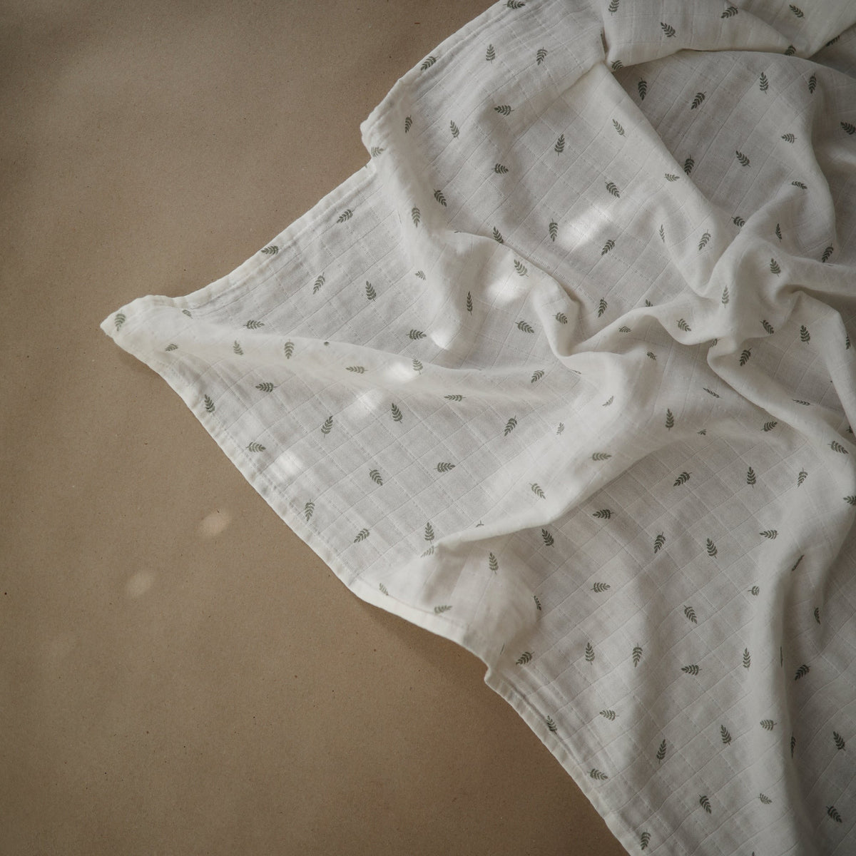 Soft Mushie organic cotton muslin swaddle blanket.