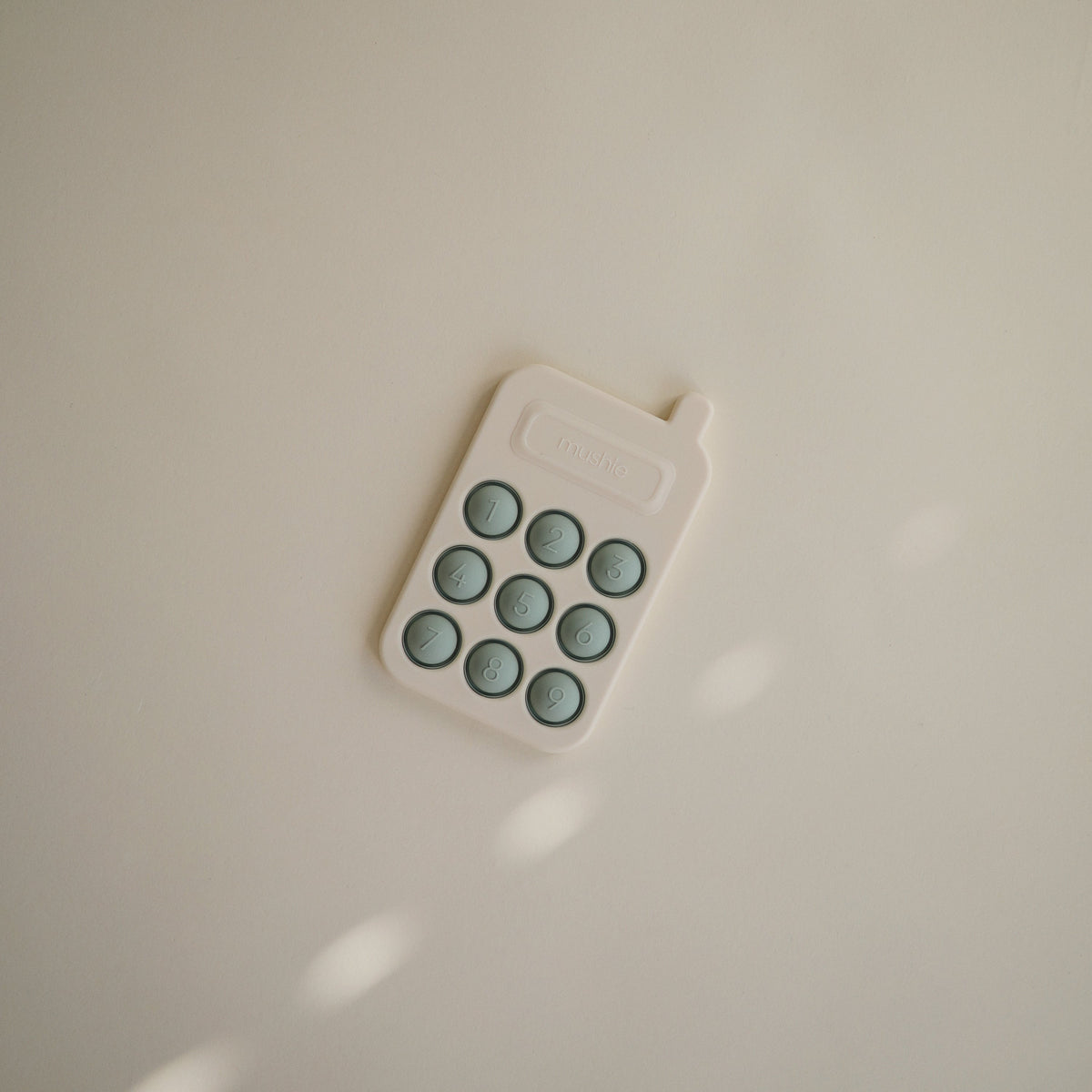 Silicone Phone Press Toy by Mushie
