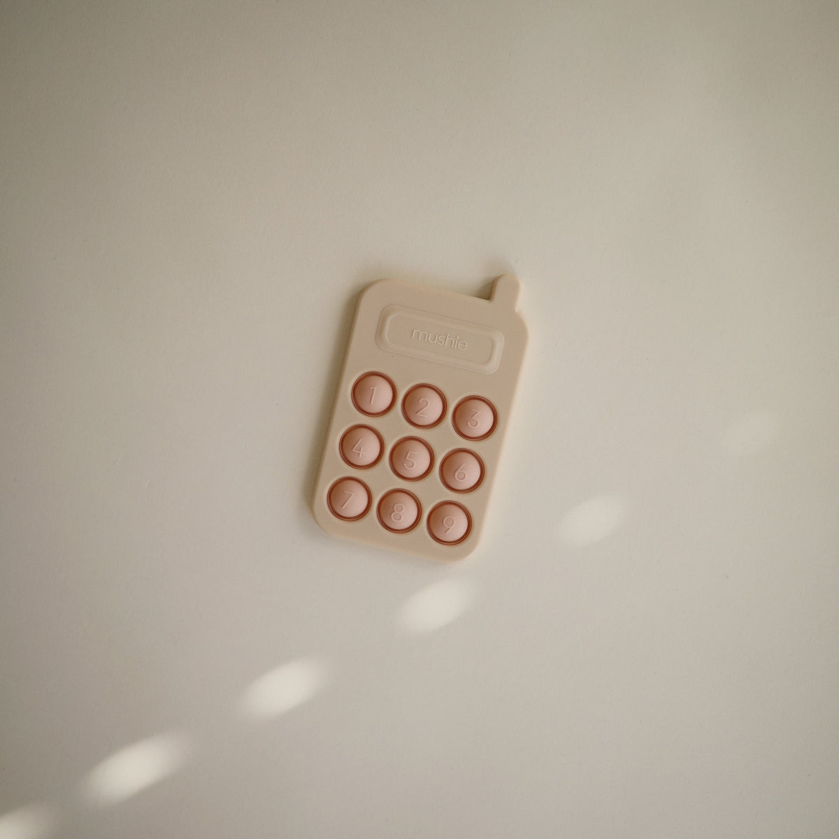 Silicone Phone Press Toy by Mushie