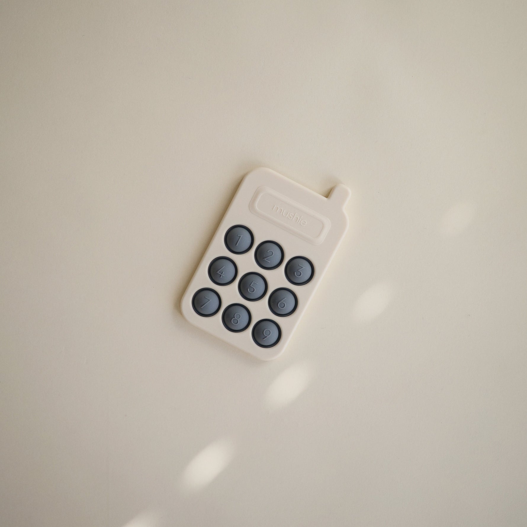 Silicone Phone Press Toy by Mushie