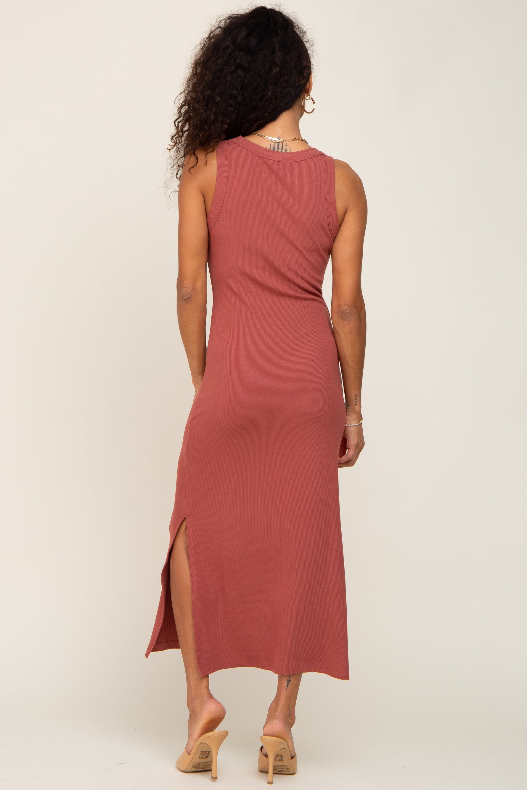 Model wearing a comfortable rust ribbed tank dress with a stylish side slit, perfect for everyday wear.