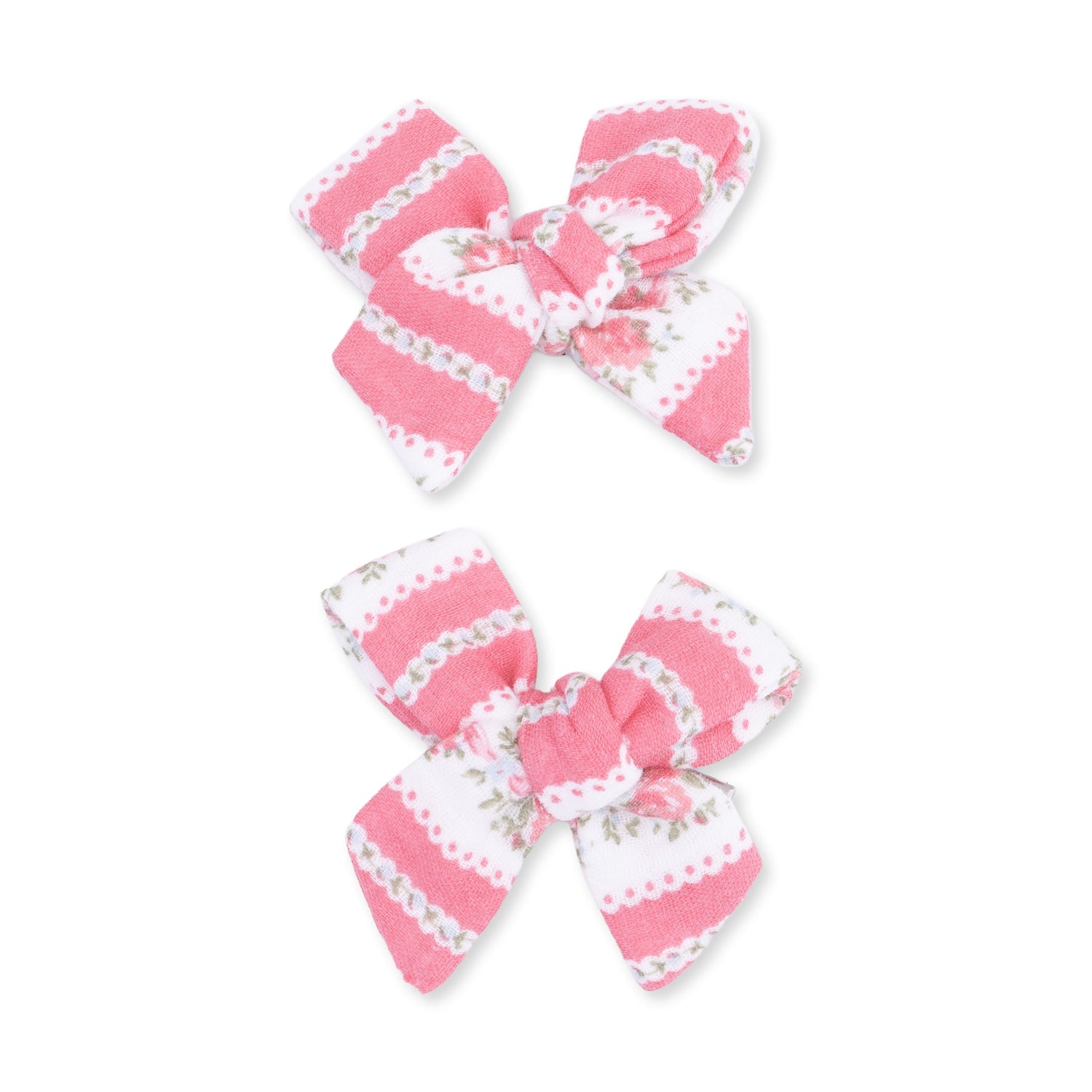 Two fabric bow hair clips in a floral stripe pattern on organic cotton muslin