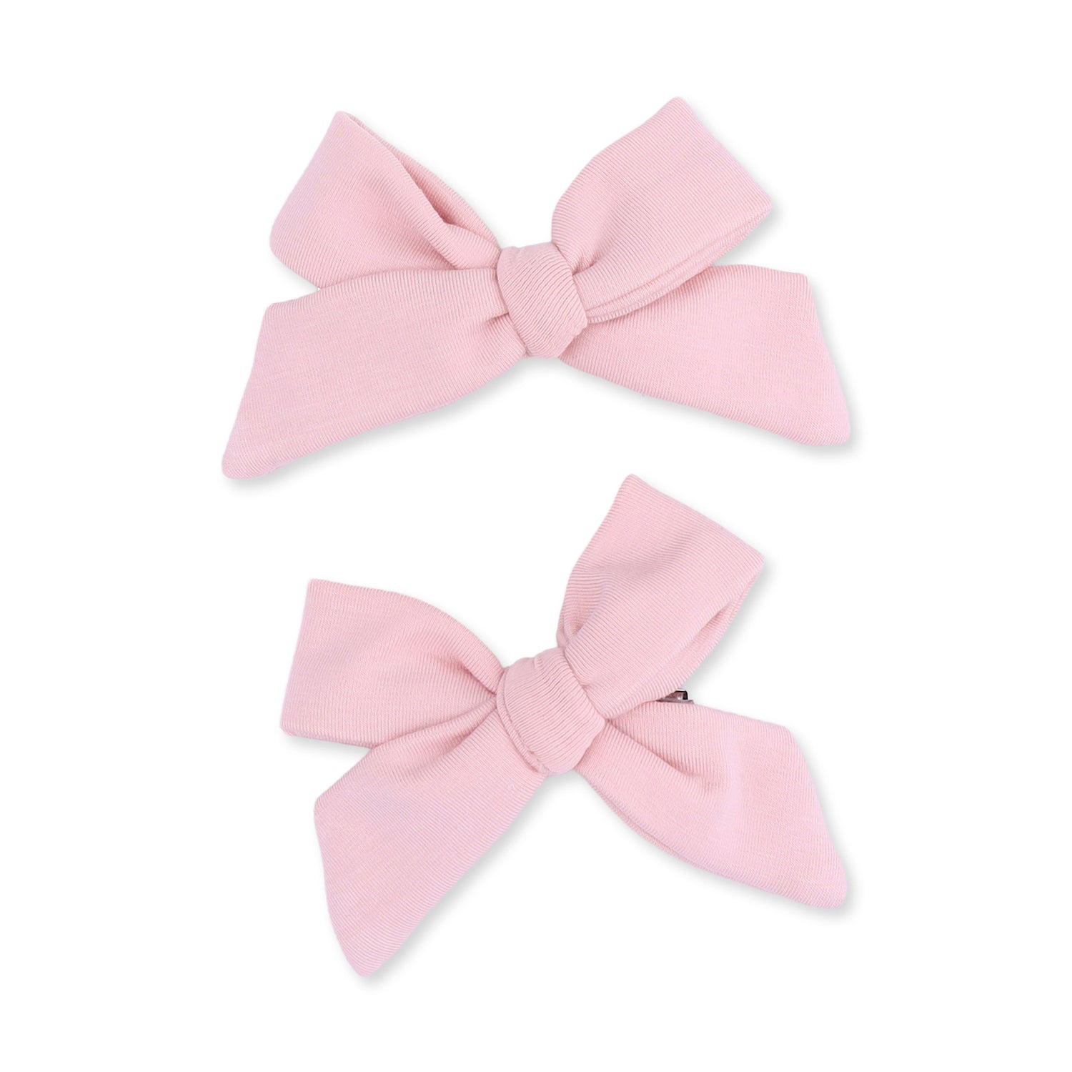 Two peachskin-colored bow hair clips in a classic bow shape