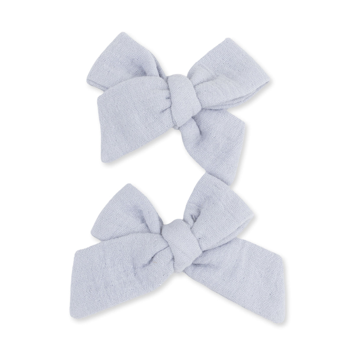 Two blue muslin bow hair clips in a matching set