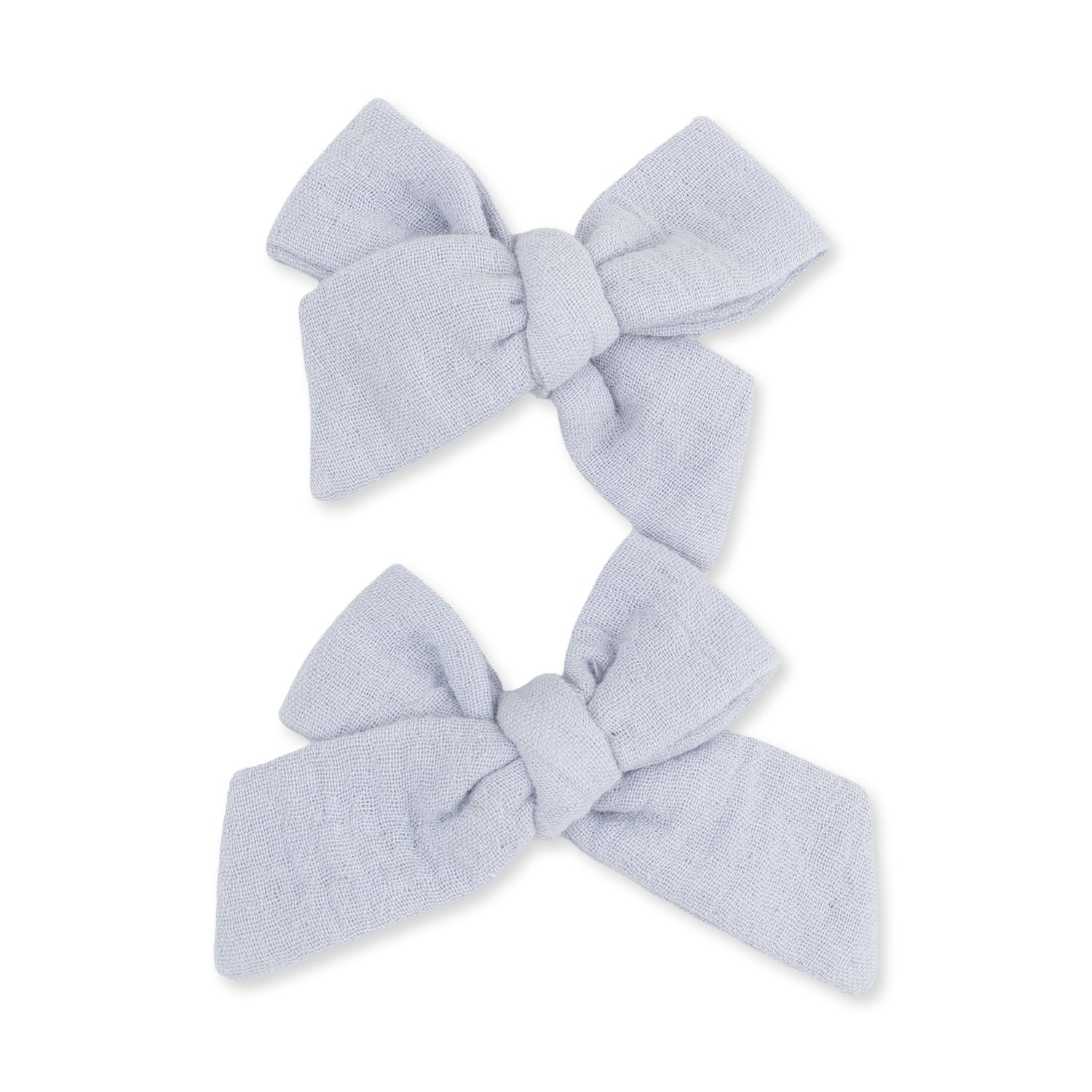 Two blue muslin bow hair clips in a matching set