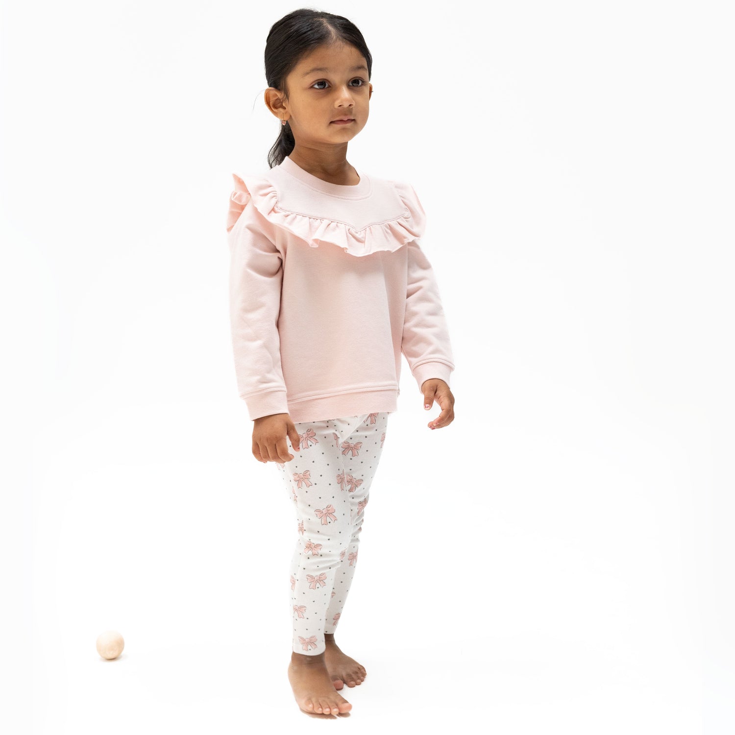 Sweatshirt with V-neck ruffle yoke and matching leggings in a pink bows print