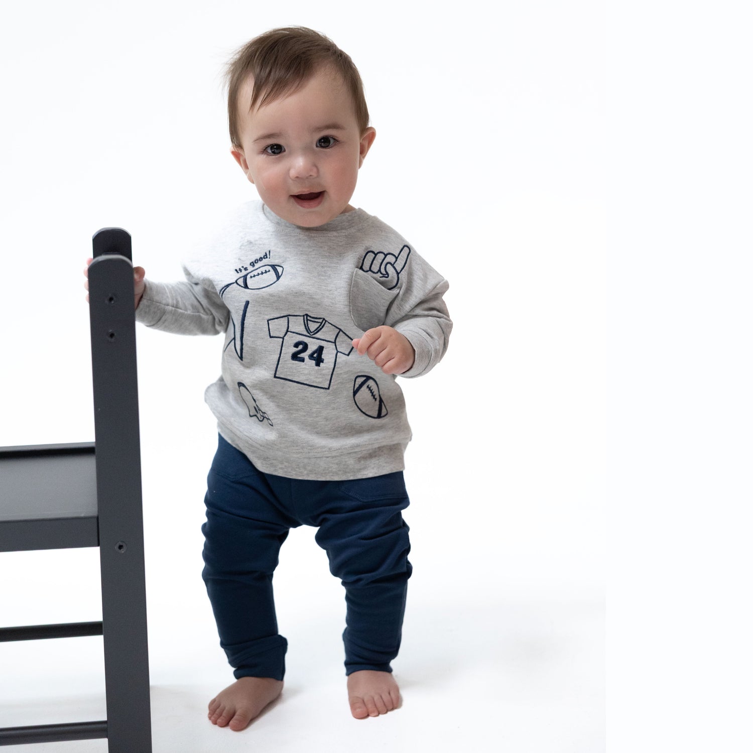 Navy drop sleeve sweatshirt with football embroidery and a front pocket.