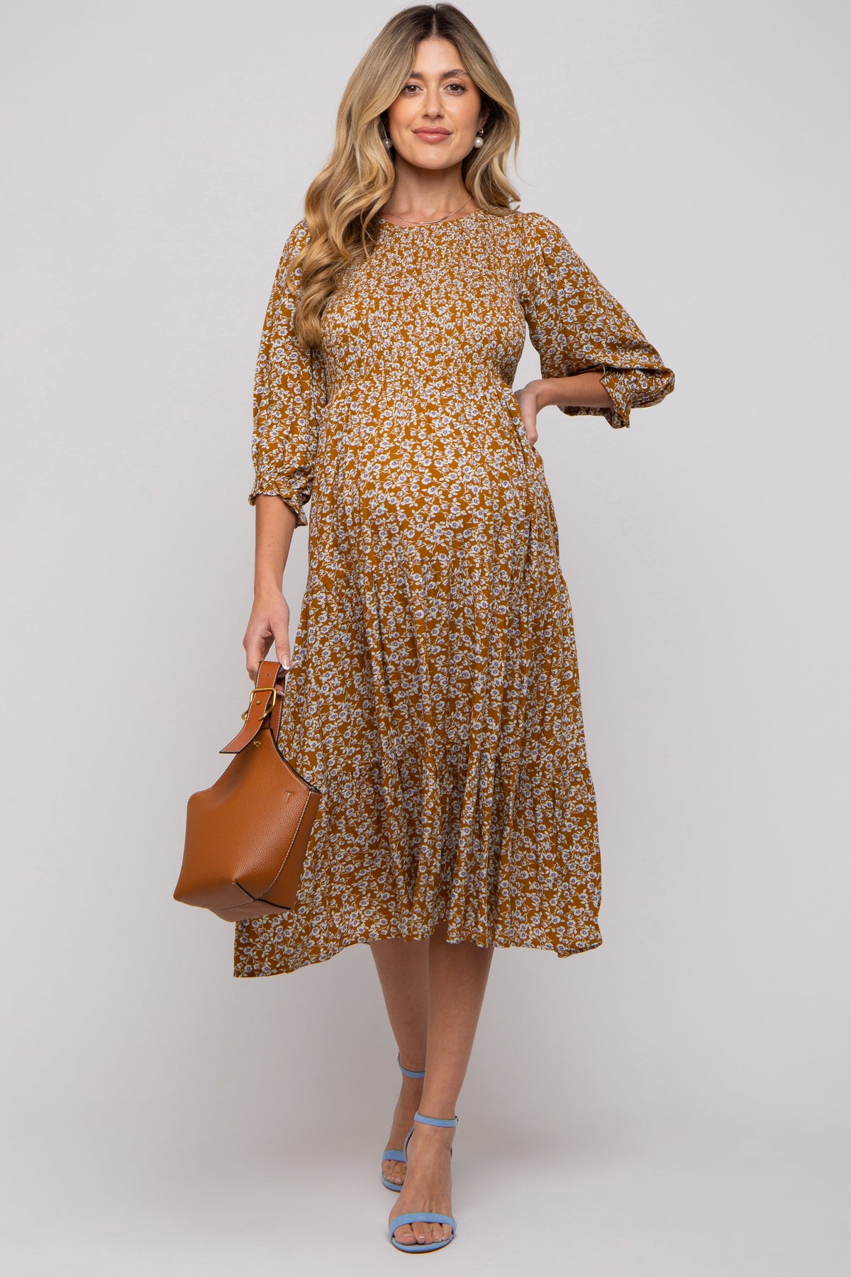 Camel floral maternity midi dress with smocked bodice, rounded neckline, 3/4 gathered sleeves, and tiered skirt.