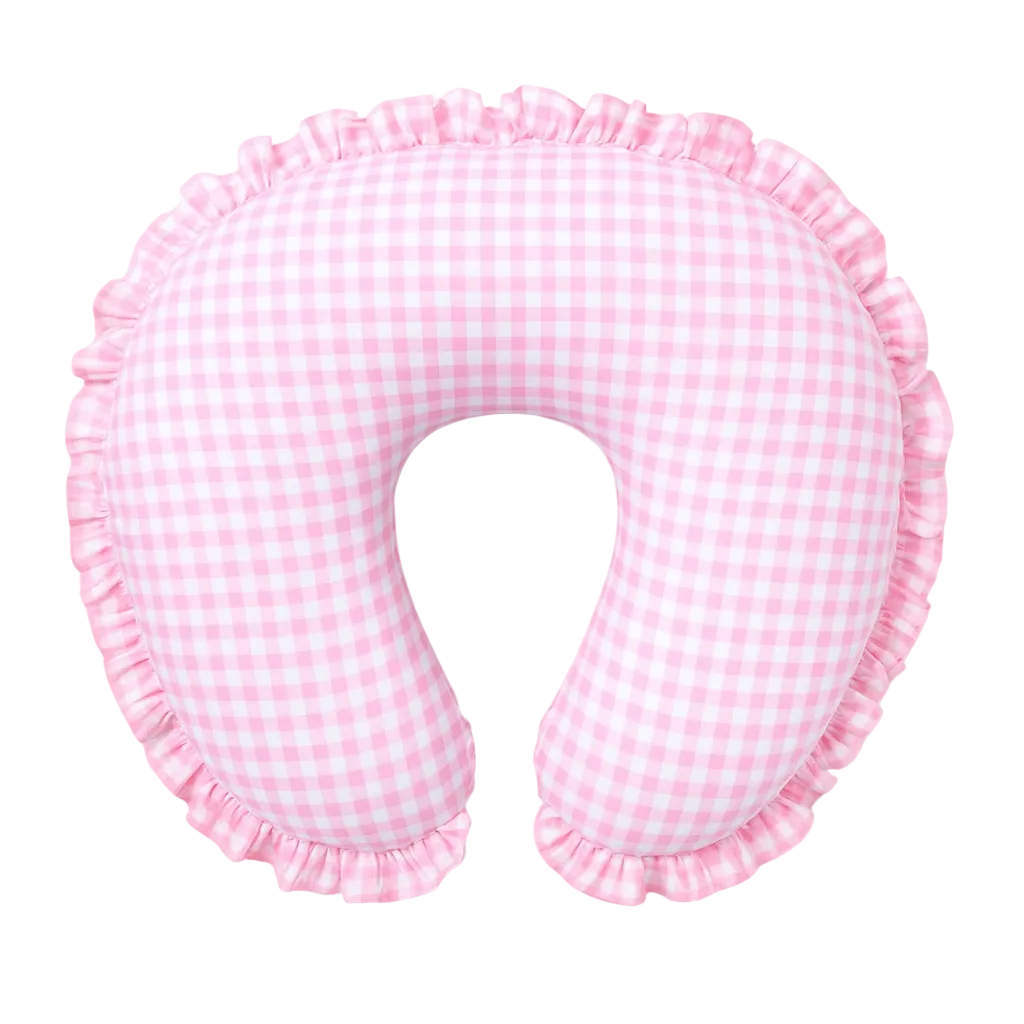 Soft pink gingham ruffle nursing pillow cover by Little Mae & Co, styled in a cozy baby nursery.