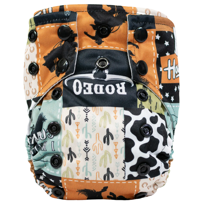 Tiny Tushies Newborn AIO Cloth Diaper with rodeo print and secure closure snaps.