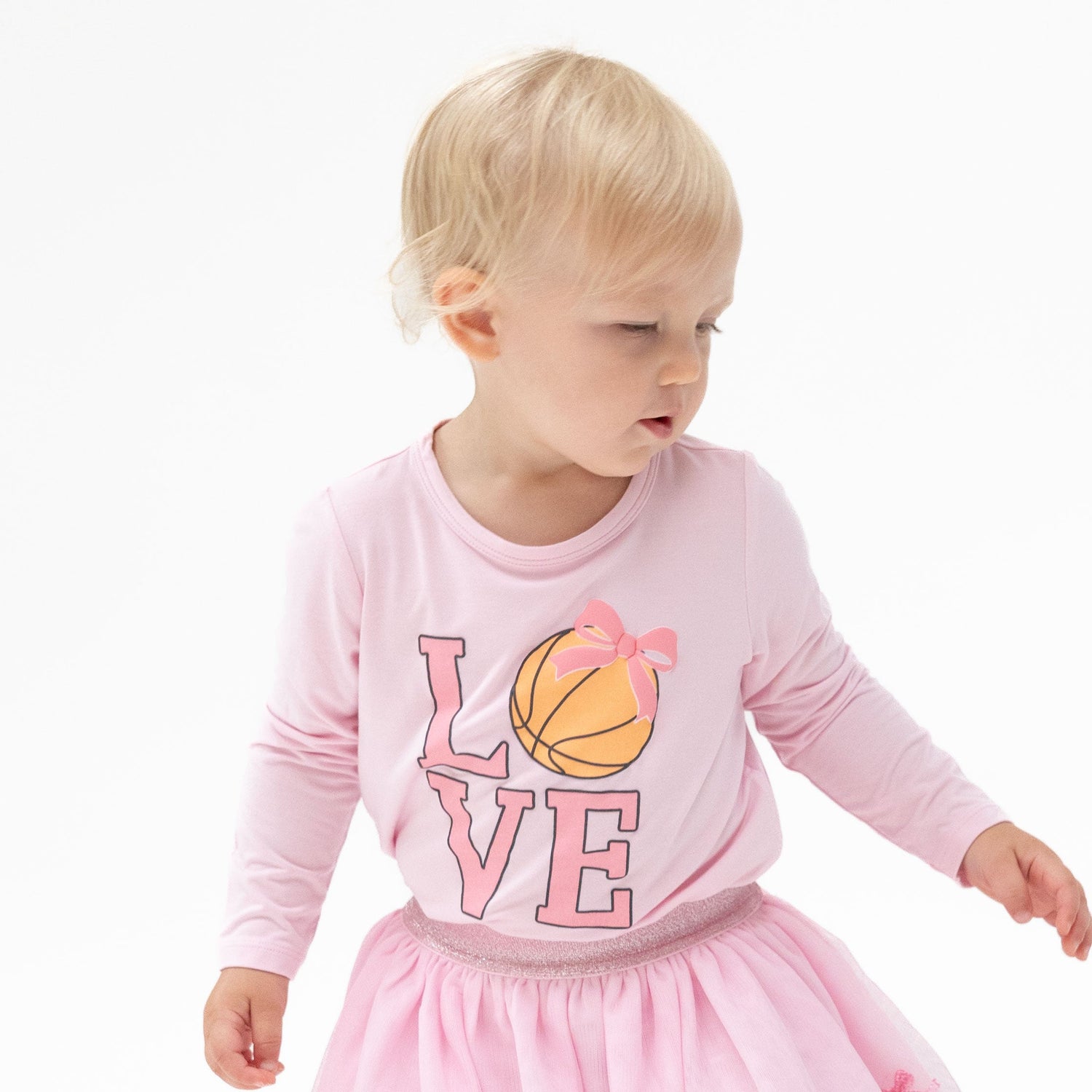 Pink long sleeve shirt with puff-print "Love" spelling out a basketball for the letter O