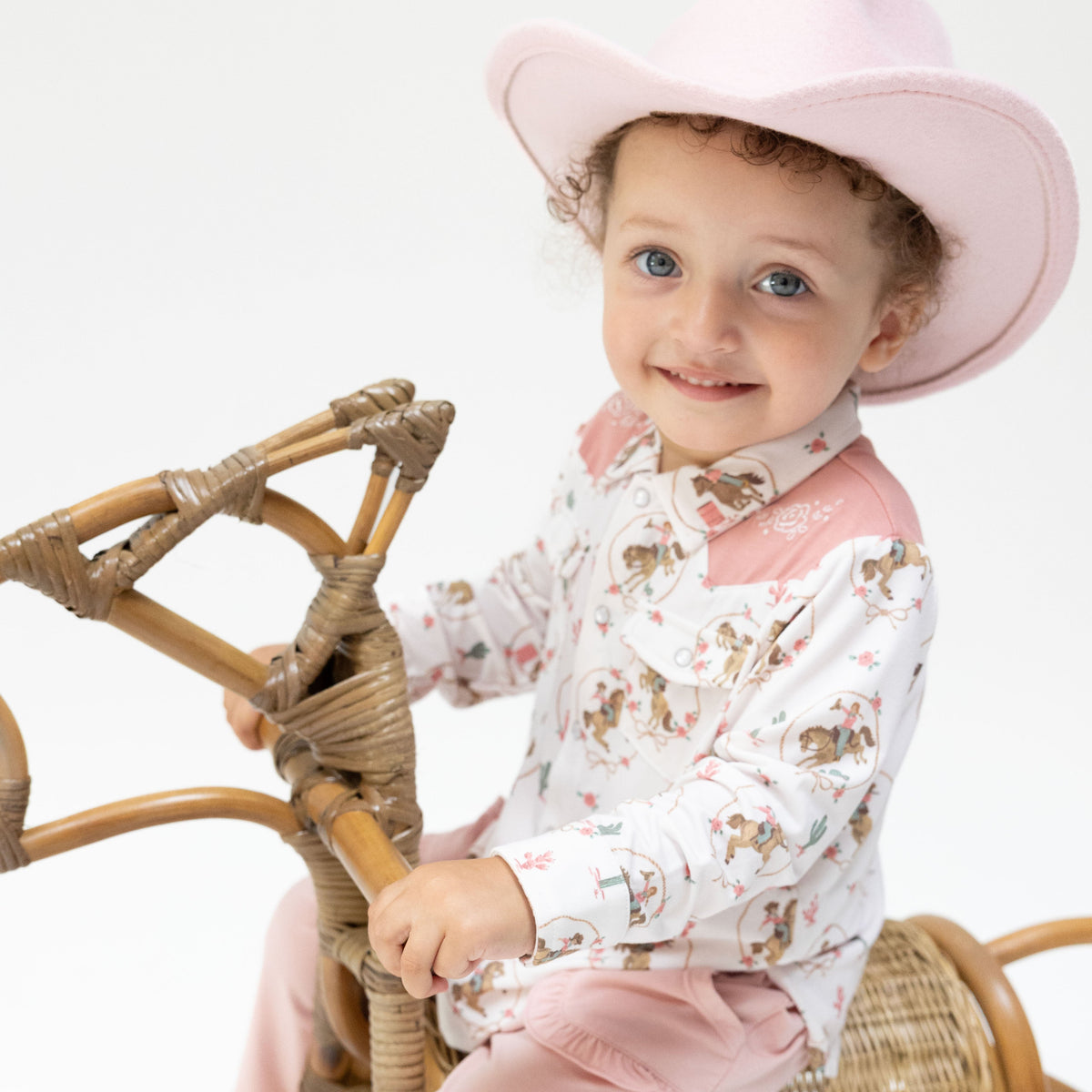 Long sleeve baby western shirt in Cowgirl Cameos print with pearl snap buttons down the front