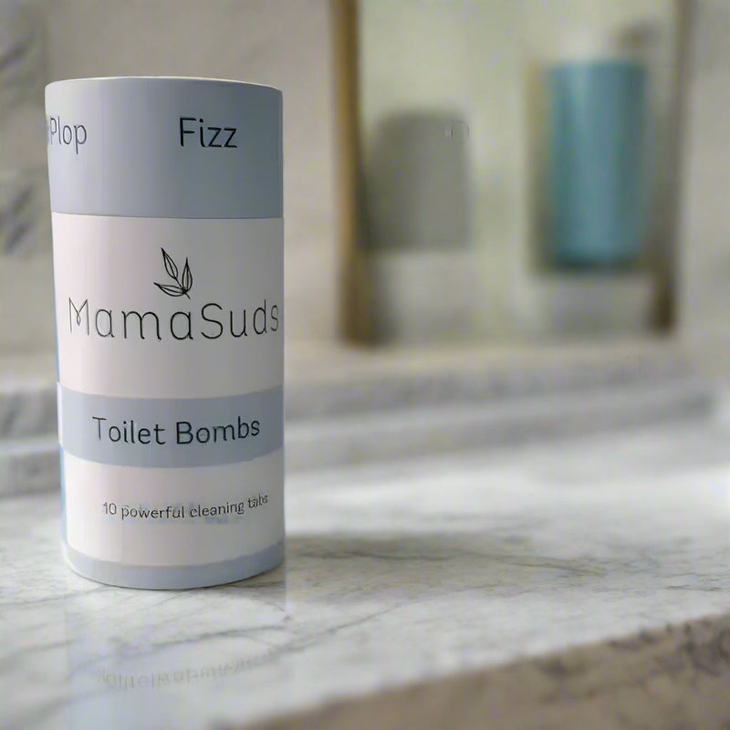 MamaSuds Toilet Bomb Cleaning Tabs in plastic-free packaging on marble surface.