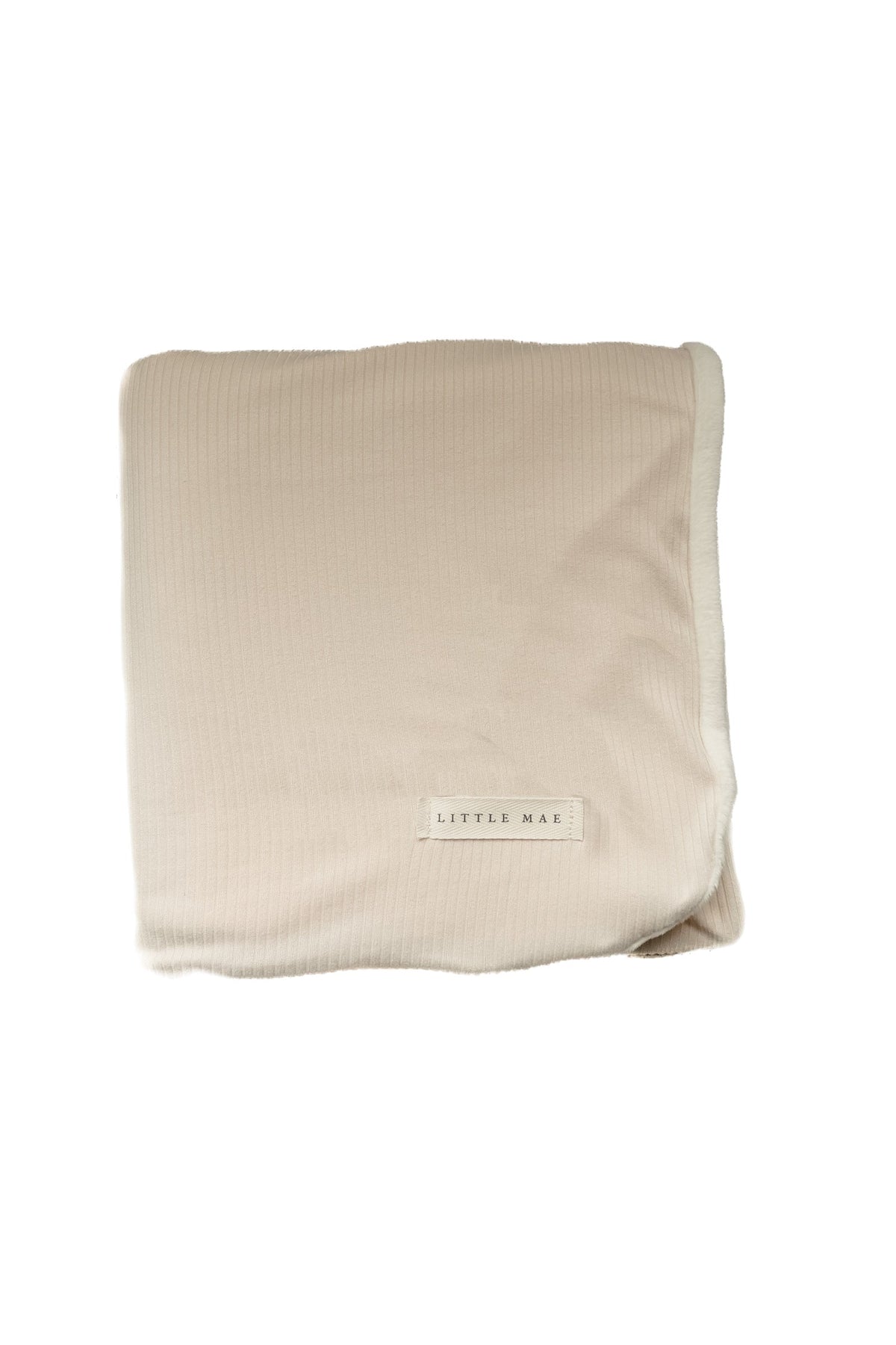 Oat ribbed toddler blanket in a neutral oatmeal tone, laid flat to show its ribbed texture.