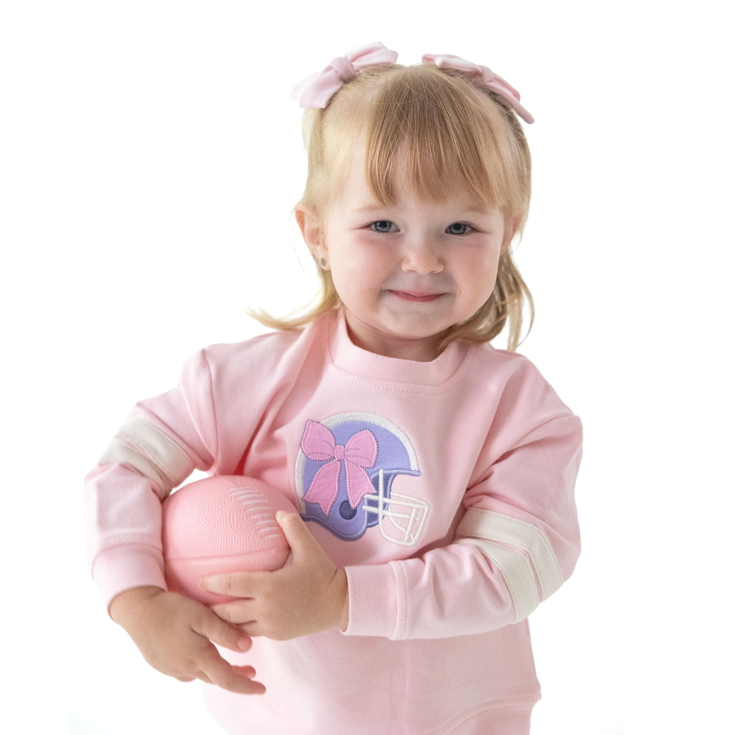 Pink drop sleeve sweatshirt with varsity stripes and a purple football helmet applique