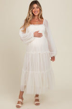 Woman modeling a PinkBlush Cream Mesh Tiered Long Sleeve Maternity Maxi Dress, looking elegant.