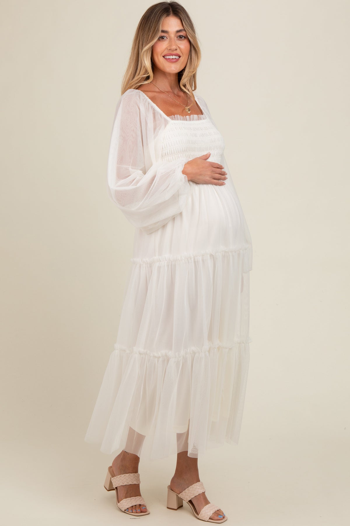 Woman modeling a PinkBlush Cream Mesh Tiered Long Sleeve Maternity Maxi Dress, looking elegant.
