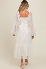 Woman modeling a PinkBlush Cream Mesh Tiered Long Sleeve Maternity Maxi Dress, looking elegant.