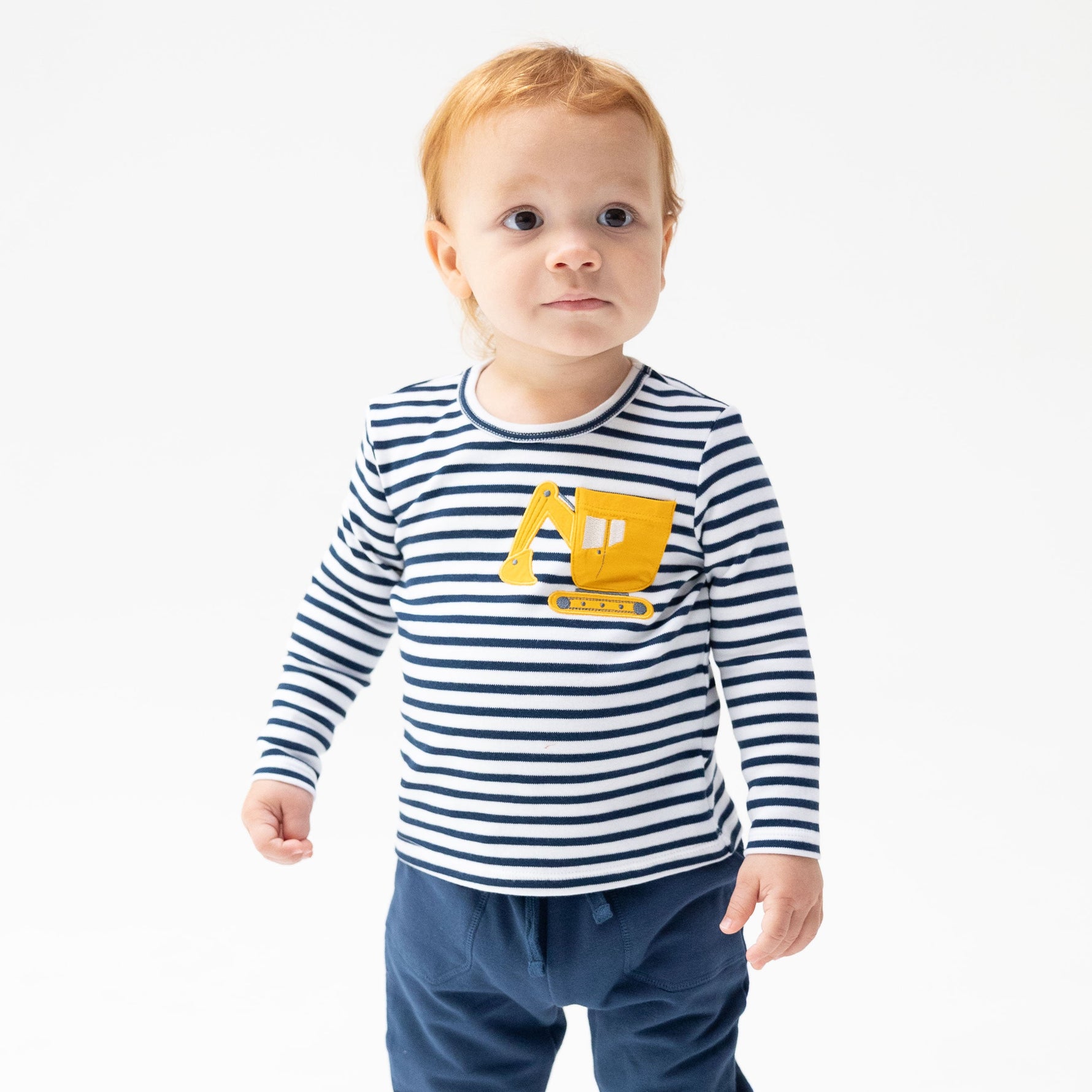Long sleeve baby shirt with a construction digger truck applique pocket on the front