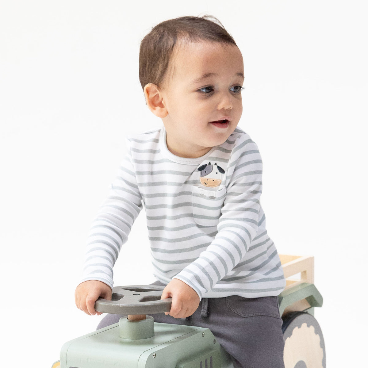 Blue long sleeve baby and toddler shirt with a cow applique peeking out of a chest pocket