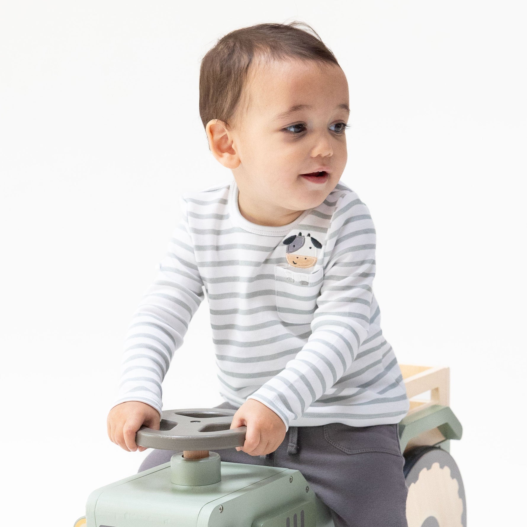 Blue long sleeve baby and toddler shirt with a cow applique peeking out of a chest pocket