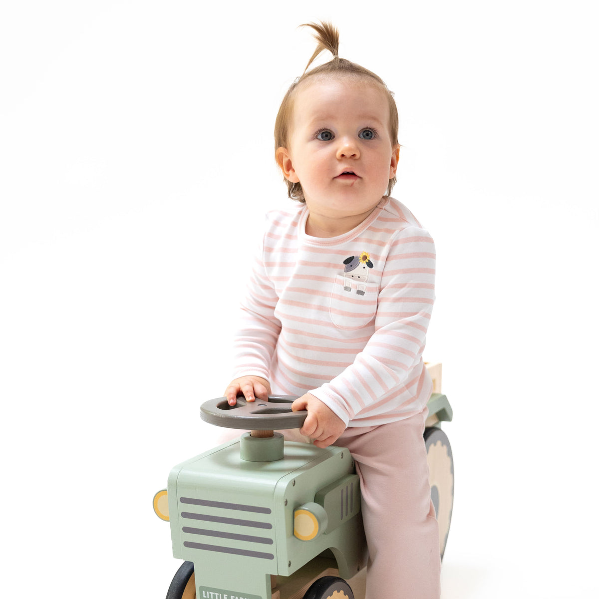 Pink long sleeve baby shirt with cow pocket applique and a sunflower tucked behind the cow's ear
