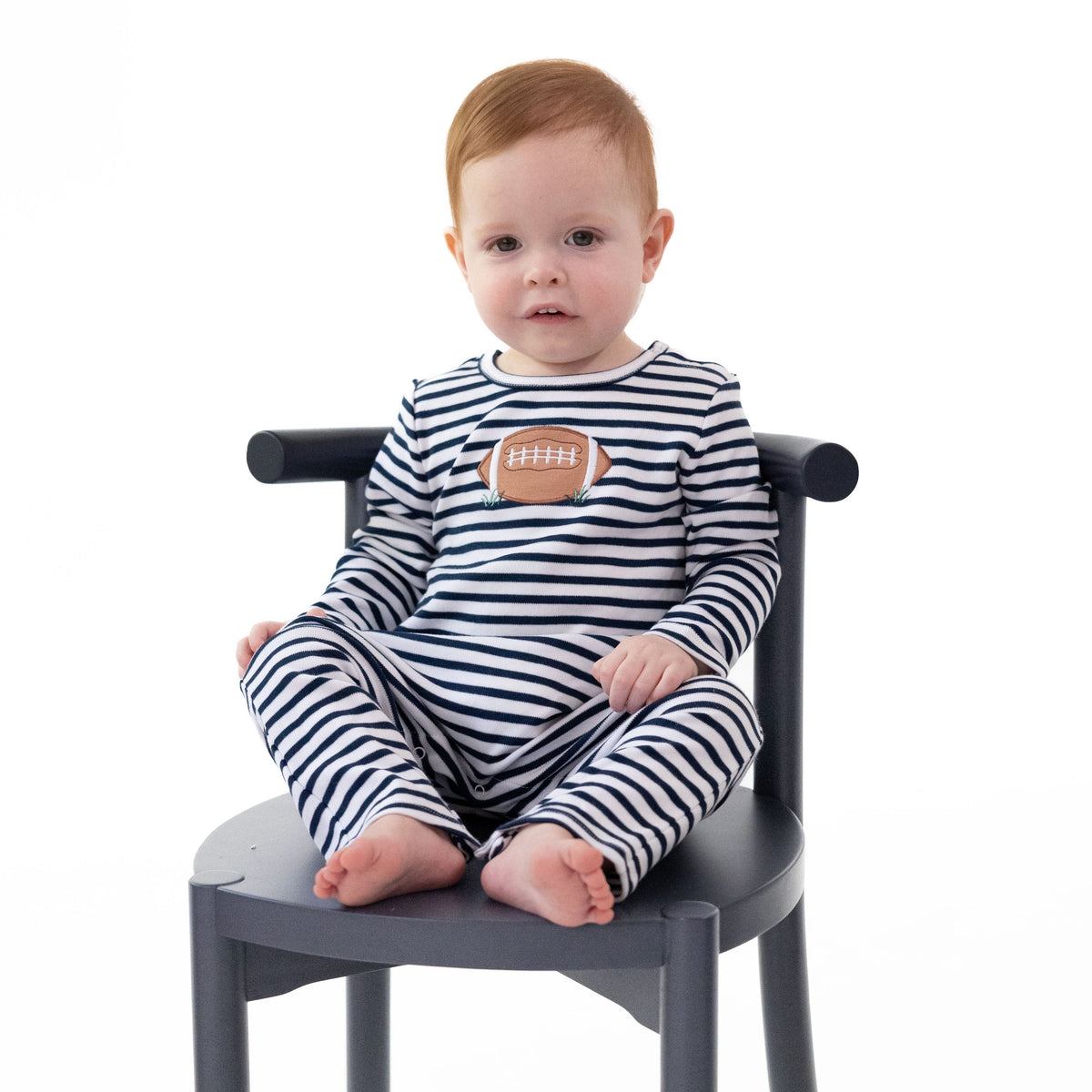 Navy long sleeve baby romper with football applique, snap shoulders and snap legs