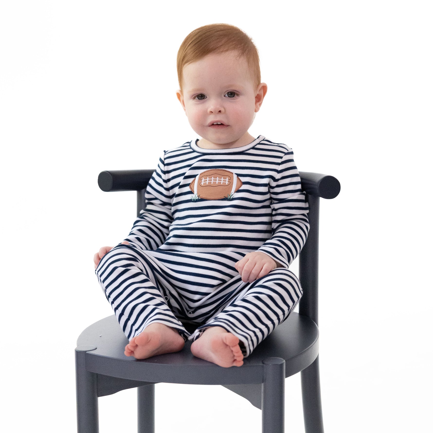 Navy long sleeve baby romper with football applique, snap shoulders and snap legs