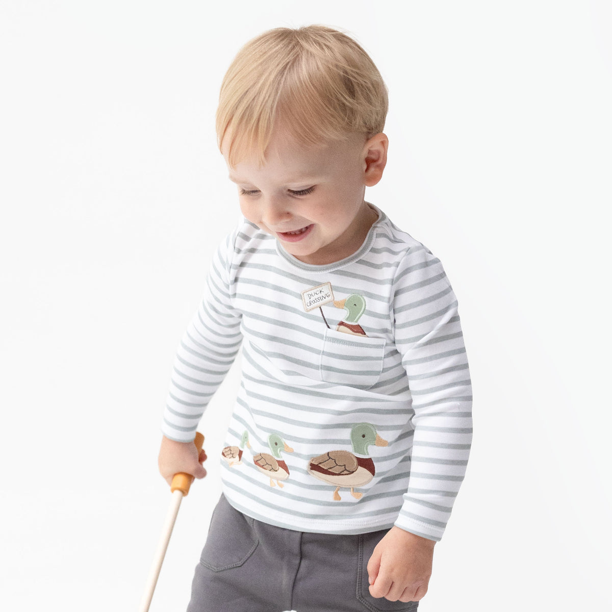 Long sleeve baby shirt with applique of a mama mallard duck leading her ducklings across the front