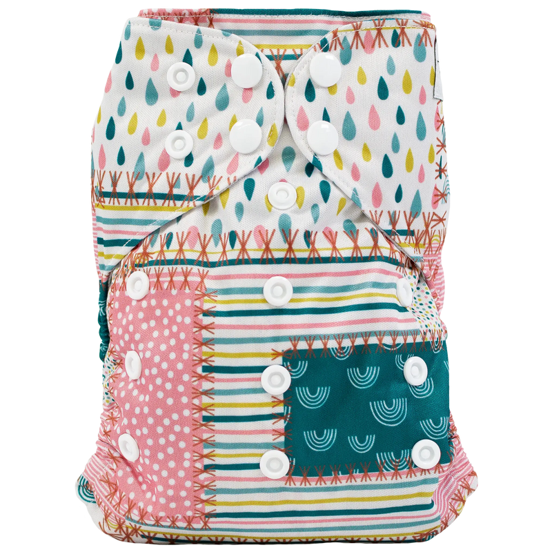 Colorful slim fit pocket cloth diaper with multiple snap closures and vibrant printed patterns.