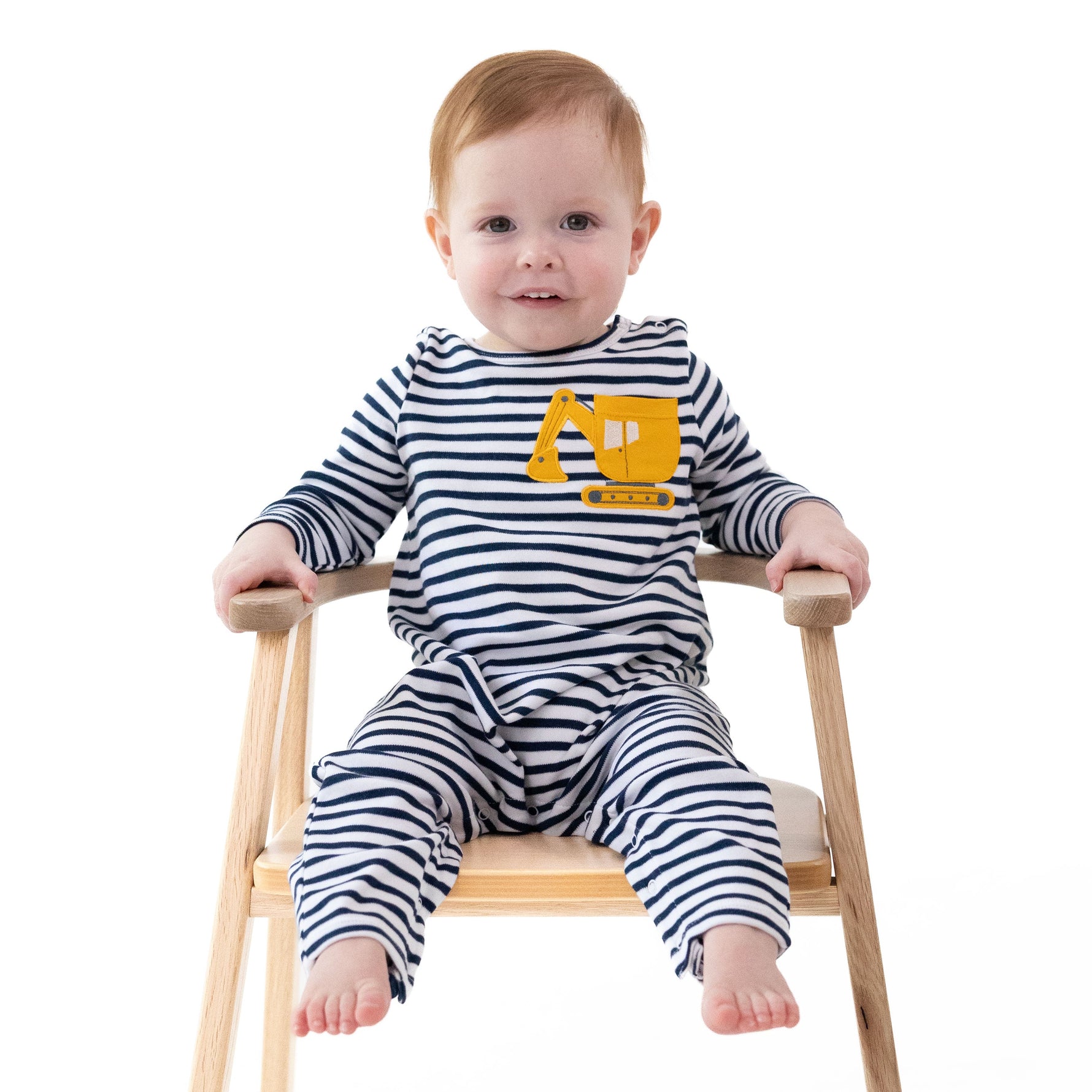 Long sleeve baby romper with snap shoulders and legs, featuring a digger construction truck pocket applique