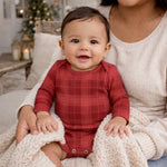 Red plaid baby bodysuit with envelope neckline and snap closures at the legs
