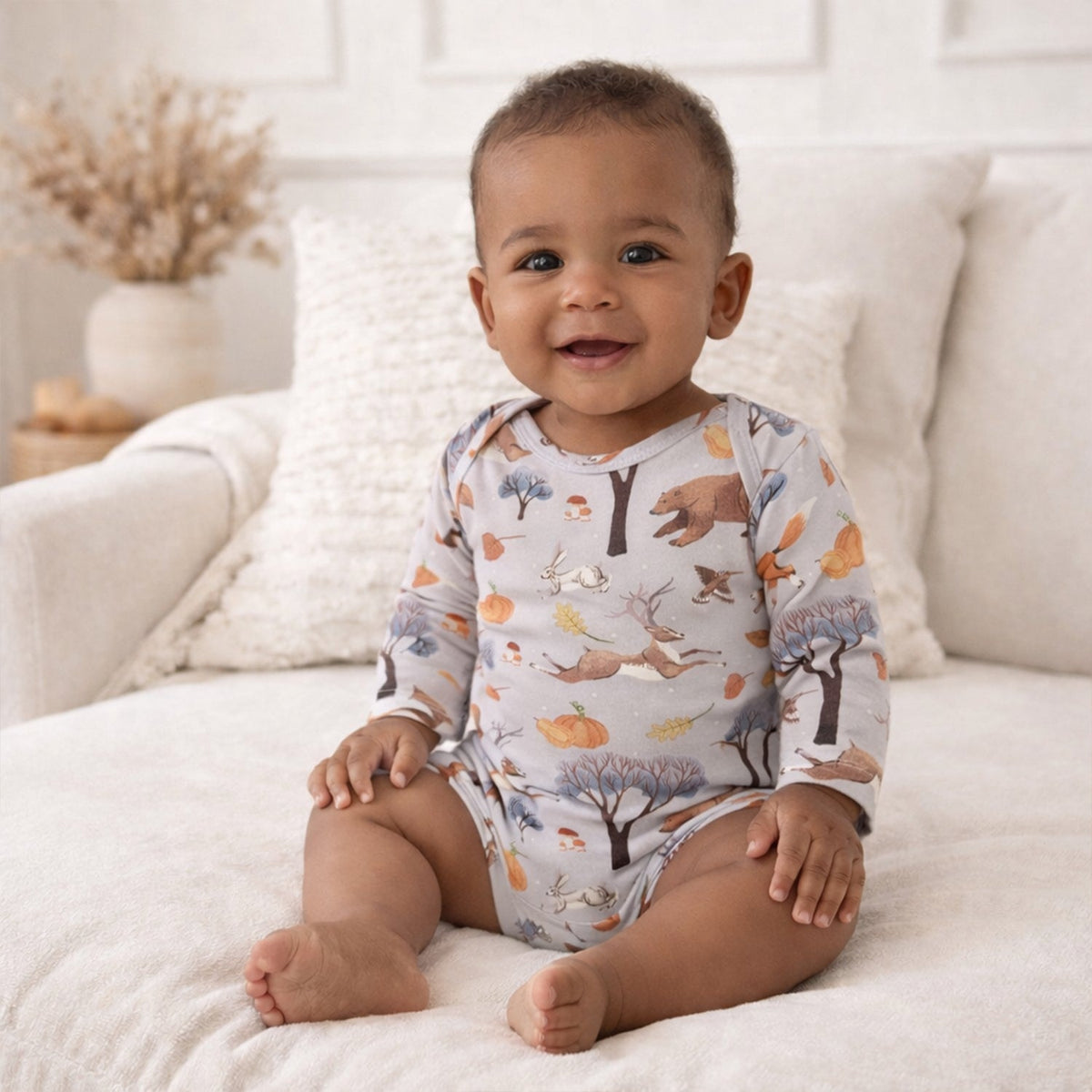 Long-sleeve baby bodysuit with a forest woodland print and envelope neckline