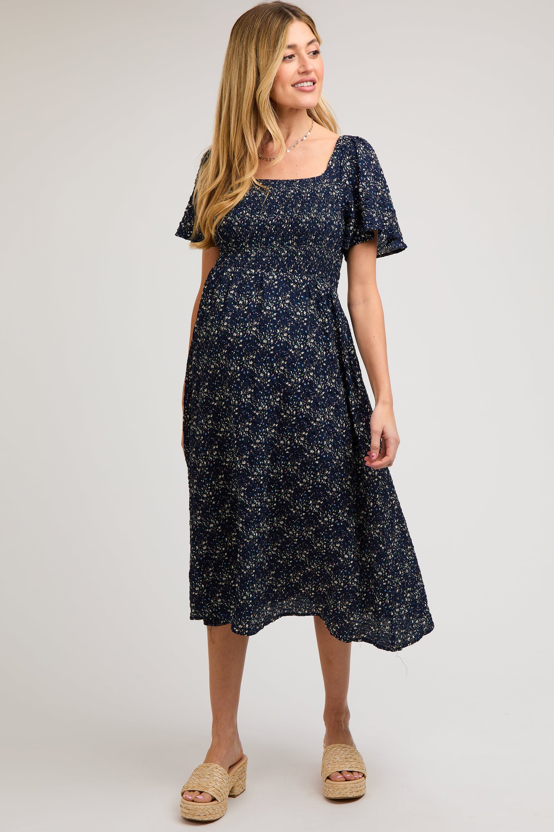Navy floral square neck maternity midi dress with short sleeves and a smocked bodice.