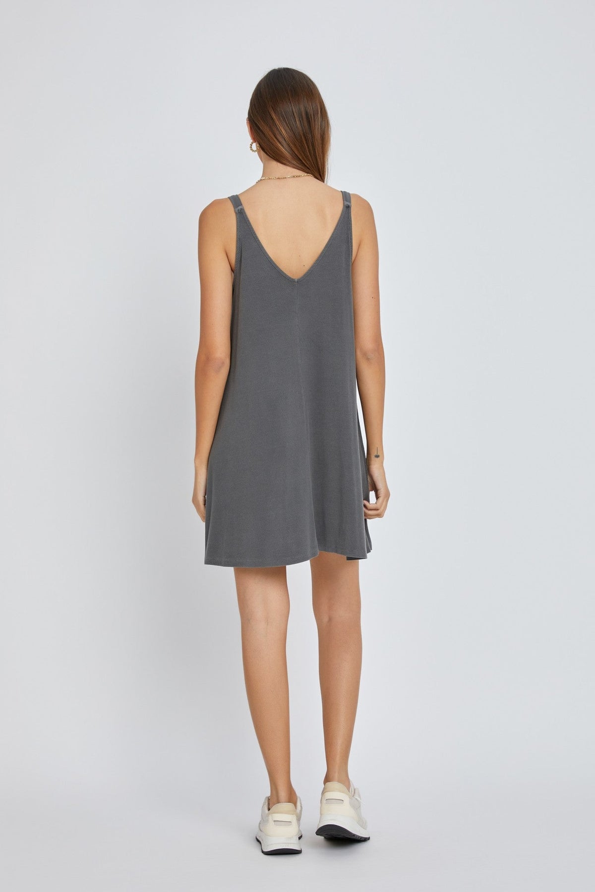 Baby wearing a soft organic charcoal ribbed sleeveless dress with a front seam detail.