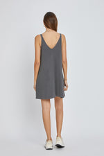 Baby wearing a soft organic charcoal ribbed sleeveless dress with a front seam detail.