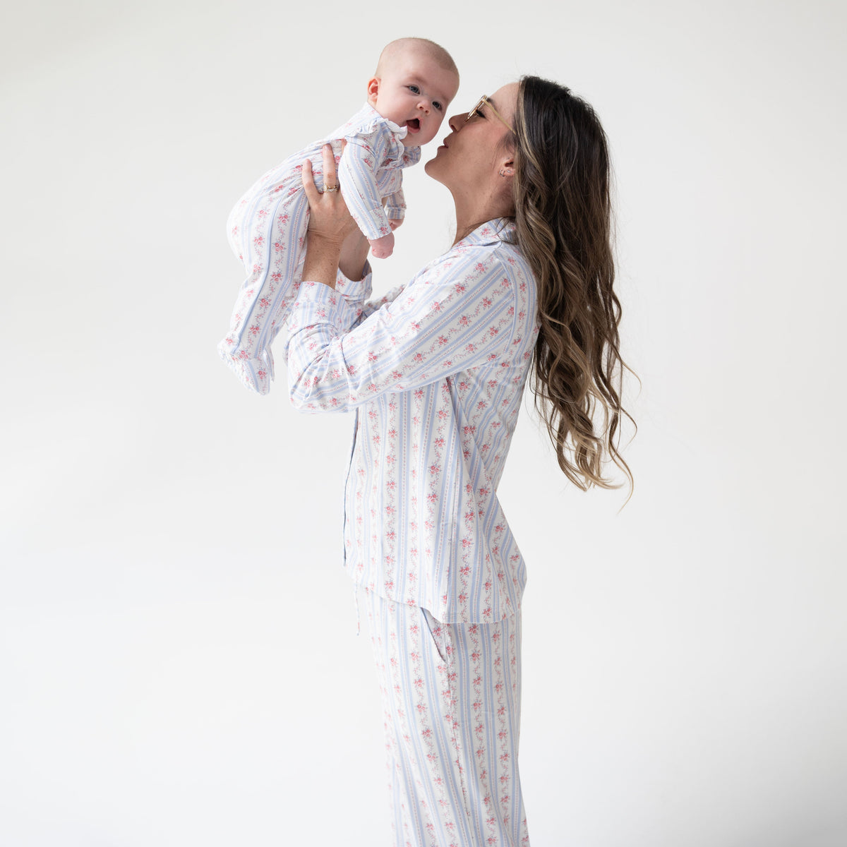 Adult long sleeve coat-style pajama top and pants in a floral stripe print with contrast piping