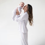Adult long sleeve coat-style pajama top and pants in a floral stripe print with contrast piping
