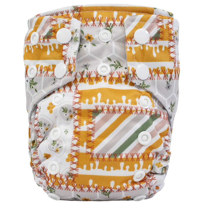 Tiny Tushies Newborn AIO Cloth Diaper with snaps and patterned design.