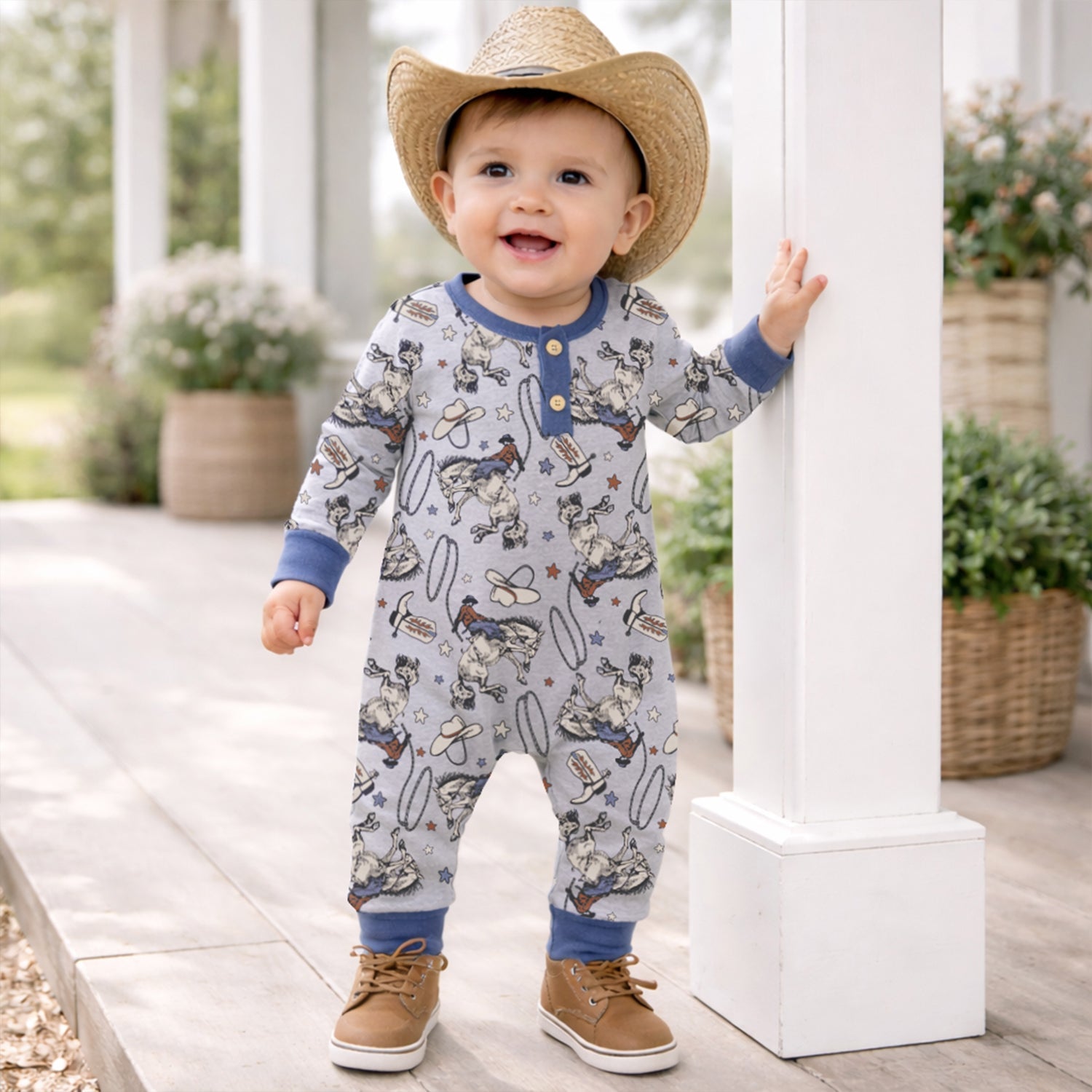 Baby romper with Western cowboy rodeo print, front Henley buttons, and ribbed cuffs.